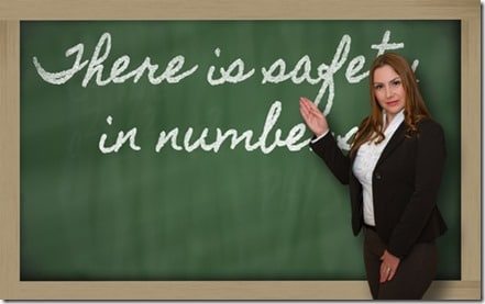 Teacher showing There is safety in numbers on blackboard